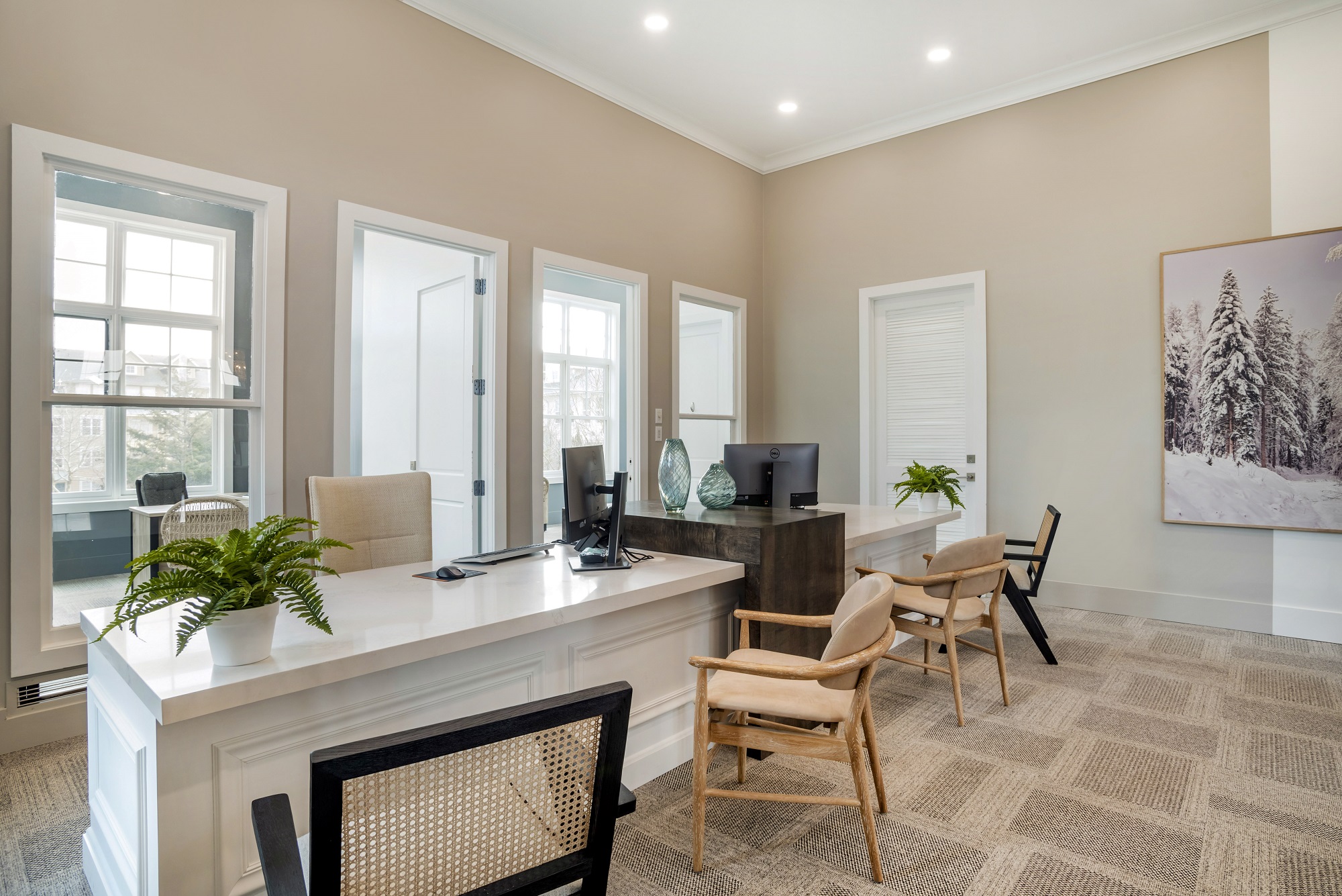 Reception desk inside leasing center with seating and carpet flooring