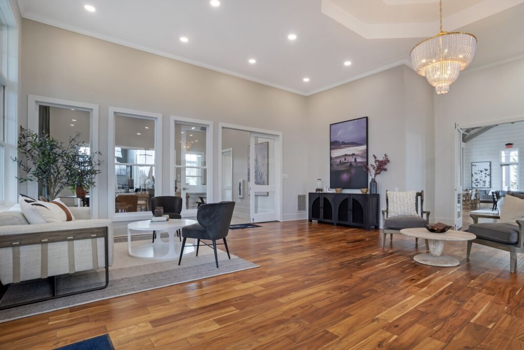 Leasing lobby area with chair and lounge seating, designer lighting, and wood-style flooring